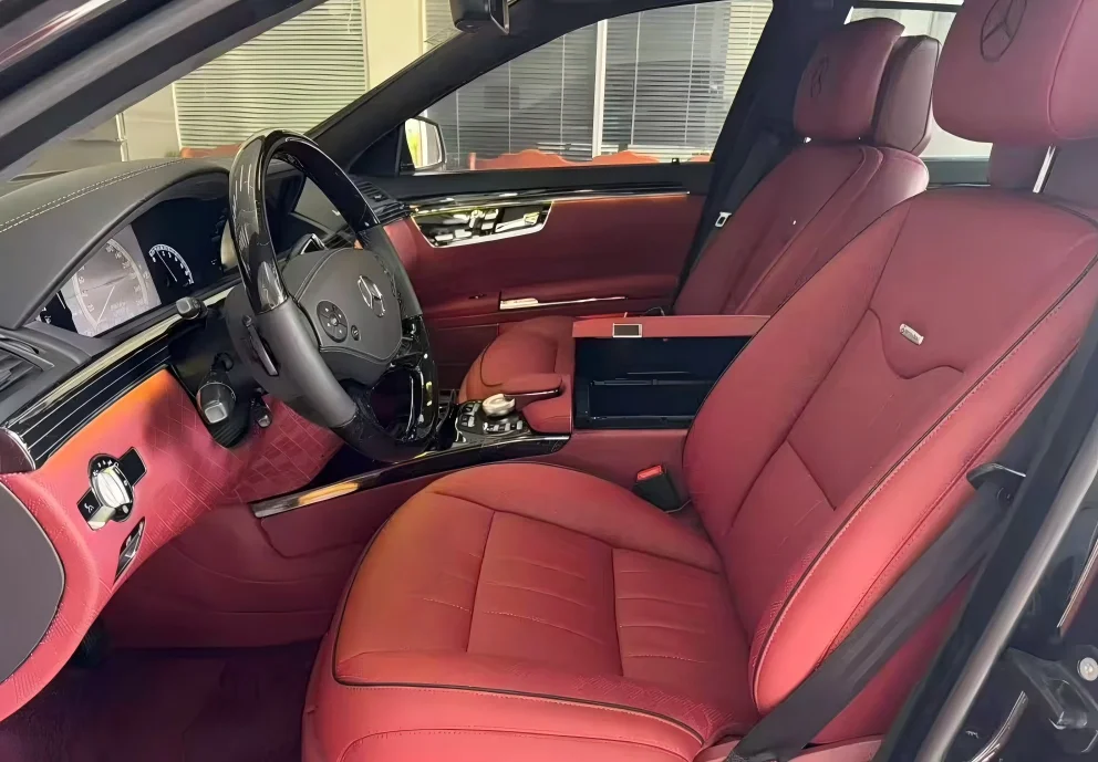 1-Modified front aviation-style seats in a Mercedes-Benz S-Class luxury sedan