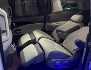 Demonstration of the Kia Carnival luxury automotive captain's seats reclined flat after installation