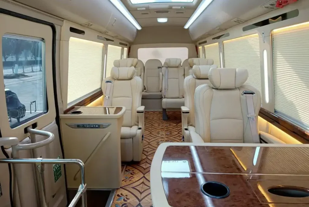2-2-Toyota Coaster luxury minibus conversion with premium leather seats and executive table configuration